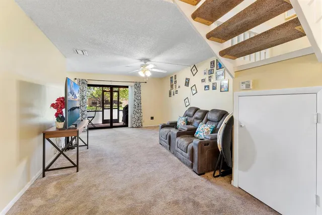 a living room with furniture and flowers