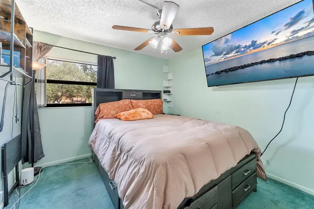 a bed sitting in a bedroom next to a window