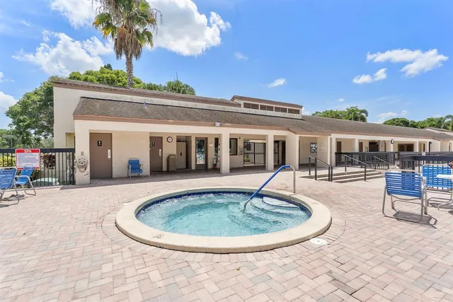 a view of a house with swimming pool and furniture