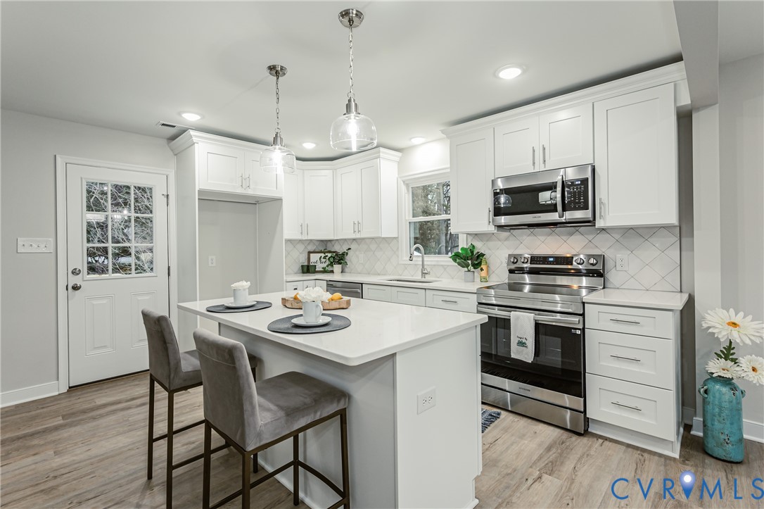 11251 Celtic Road Chesterfield, VA 23838 - Photo 12 of 49 a kitchen with kitchen island granite countertop a sink counter and appliances