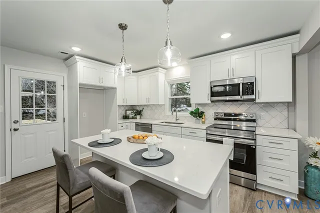 a kitchen with a stove a microwave a dining table and chairs