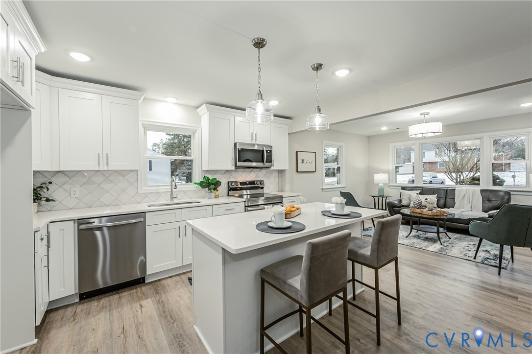 11251 Celtic Road Chesterfield, VA 23838 - Photo 15 of 49 a kitchen with stainless steel appliances kitchen island granite countertop a sink and cabinets