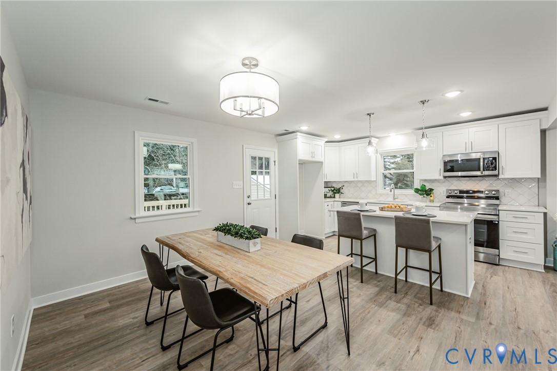 11251 Celtic Road Chesterfield, VA 23838 - Photo 21 of 49 a view of a dining room with furniture window and wooden floor