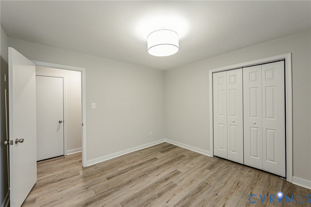 11251 Celtic Road Chesterfield, VA 23838 - Photo 25 of 49 an empty room with wooden floor and mirror