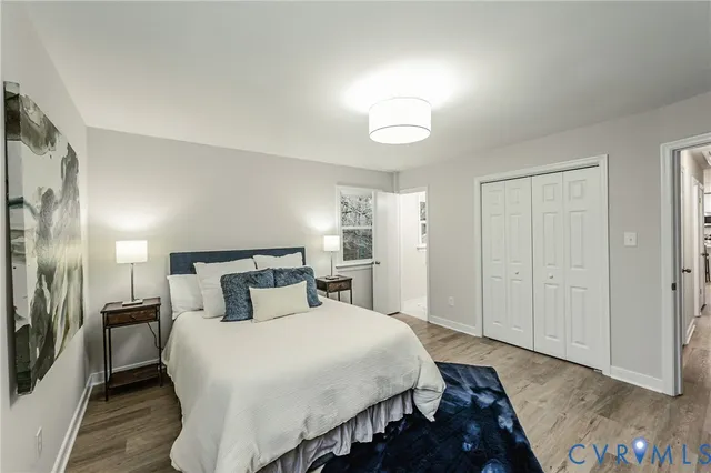 a bedroom with a bed and a night stand