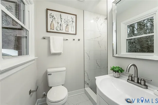 a bathroom with a toilet a sink and a large mirror