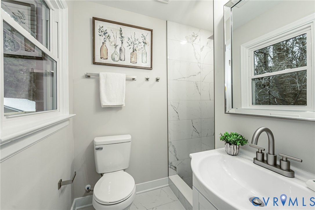 11251 Celtic Road Chesterfield, VA 23838 - Photo 32 of 49 a bathroom with a toilet a sink and a large mirror
