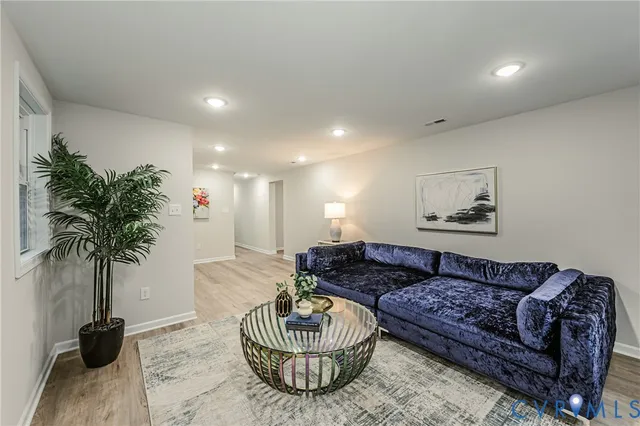 a living room with furniture and a potted plant