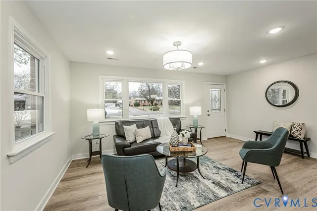 a living room with furniture a window and a table