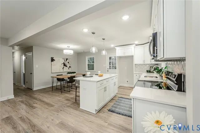 a kitchen that has a lot of cabinets a sink and appliances in it