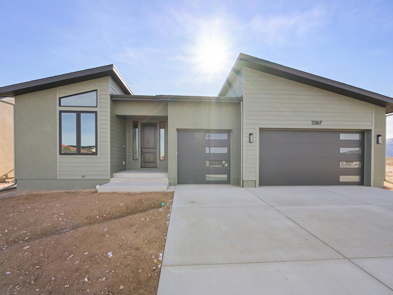 2267 Holy Cross Way Grand Junction, CO 81507 - Photo 1 of 36 a front view of a house with yard and garage