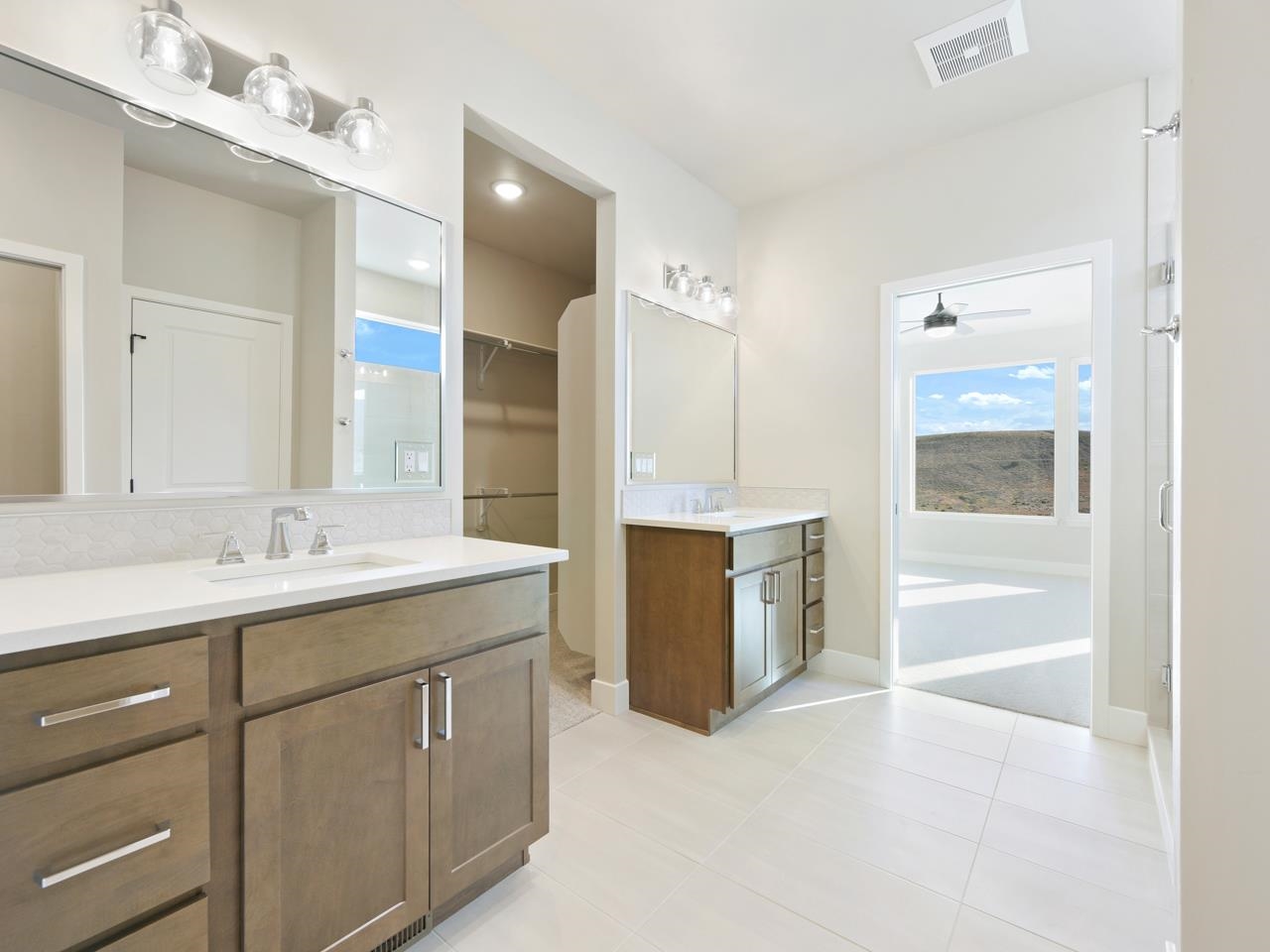 2267 Holy Cross Way Grand Junction, CO 81507 - Photo 21 of 36 a spacious bathroom with a granite countertop sink mirror and bathtub