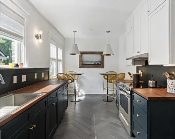 a kitchen with kitchen island granite countertop a sink counter top space appliances and a window