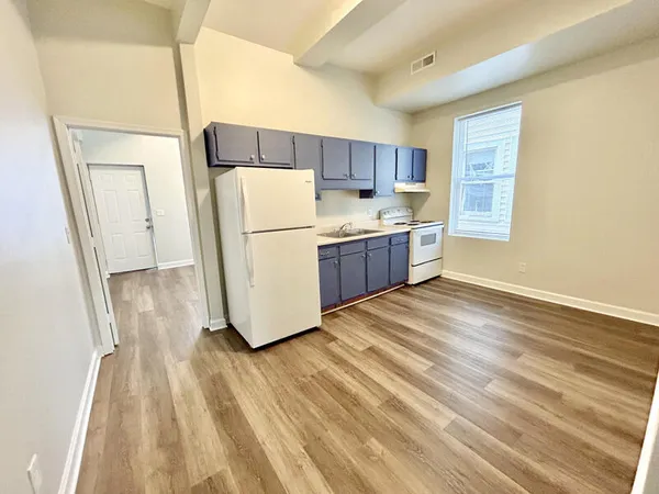 a kitchen with a refrigerator a sink and a stove