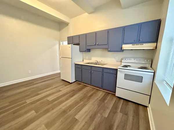 a kitchen with wooden cabinets and white appliances