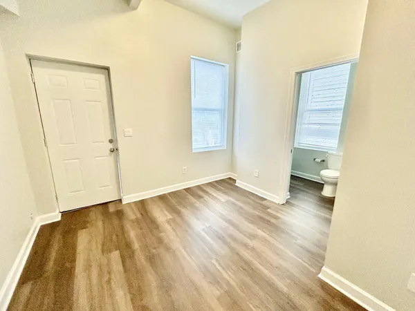a view of a room that has a sink and wooden floor
