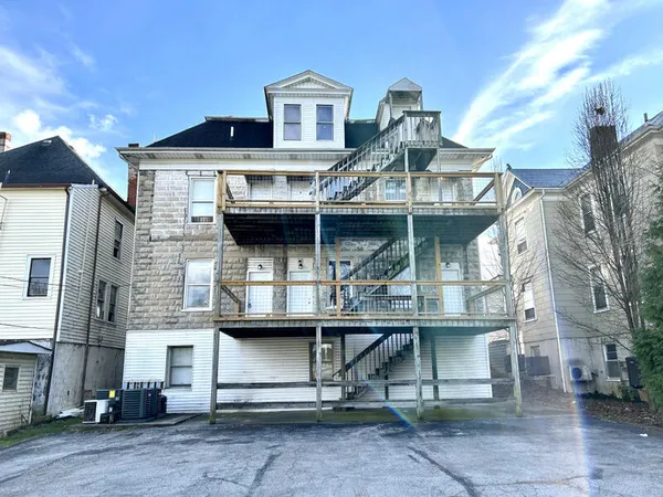 a view of a house with large windows and furniture