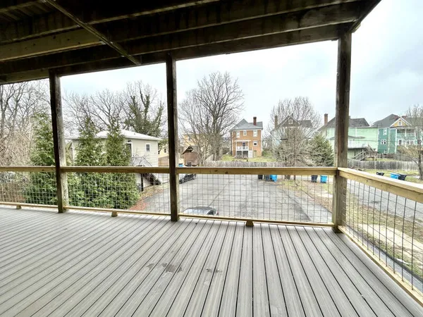 a view of a balcony with wooden floor