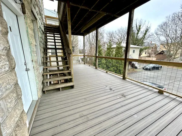 a view of balcony with wooden floor