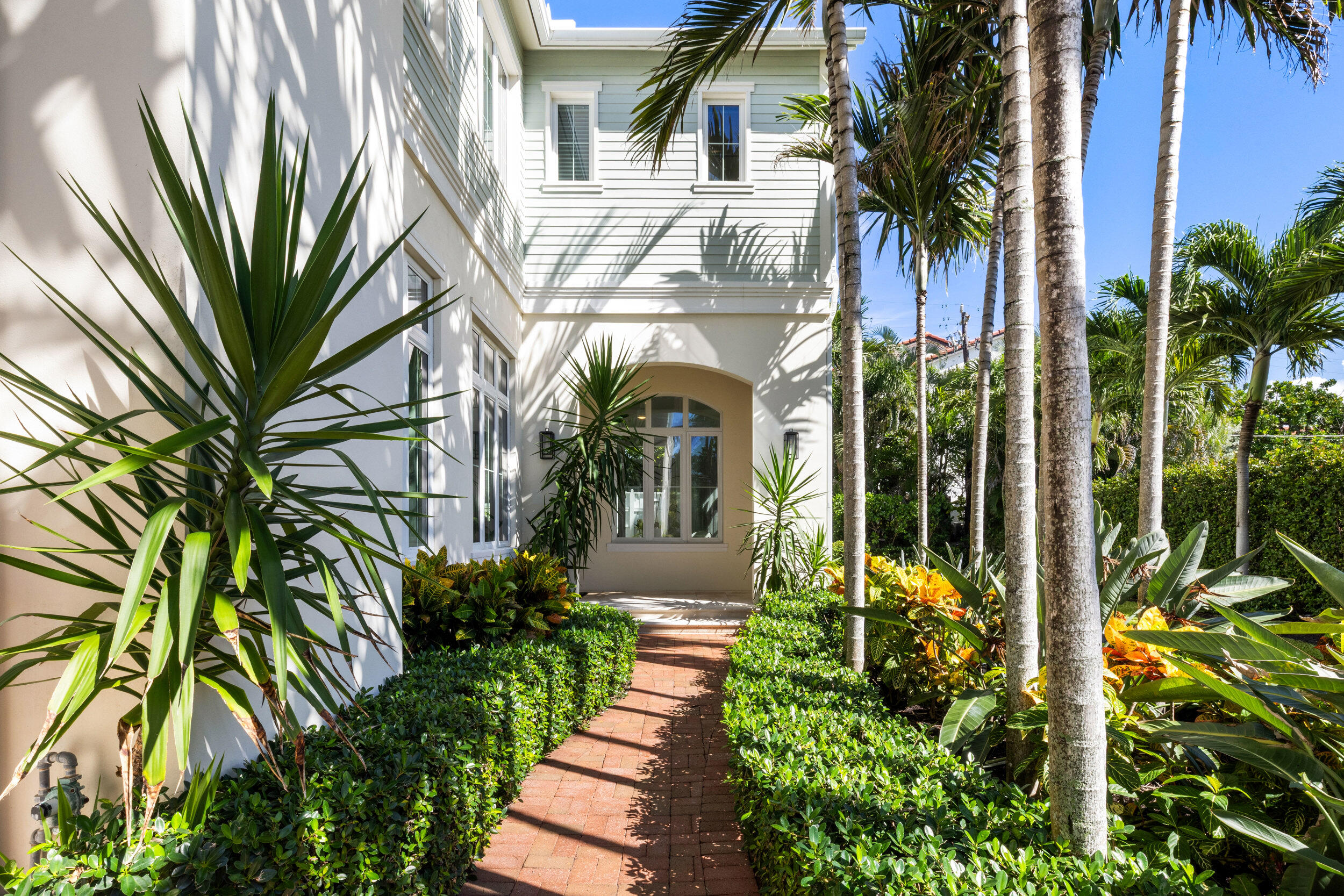 17 Adams Road Ocean Ridge, FL 33435 - Photo 3 of 41 a front view of a house with a garden