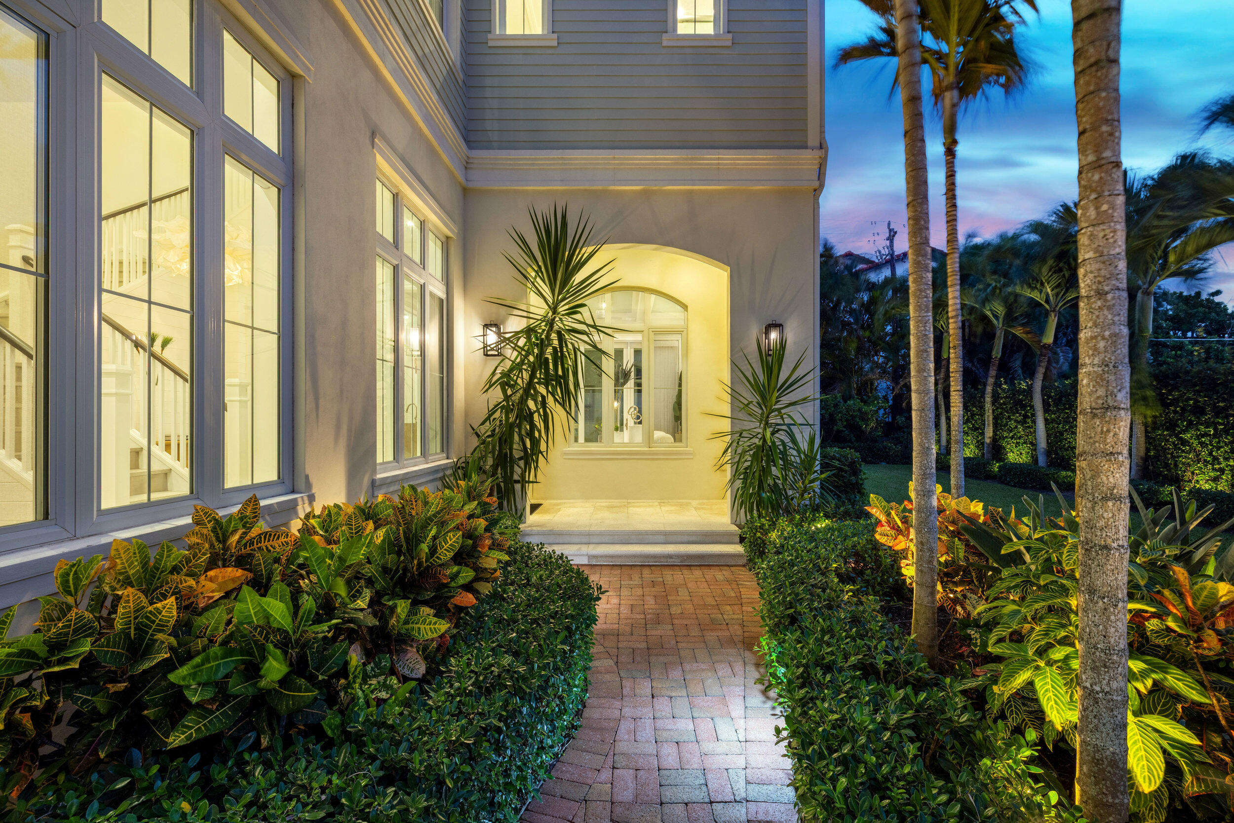 17 Adams Road Ocean Ridge, FL 33435 - Photo 32 of 41 a view of a house with large windows and flower plants