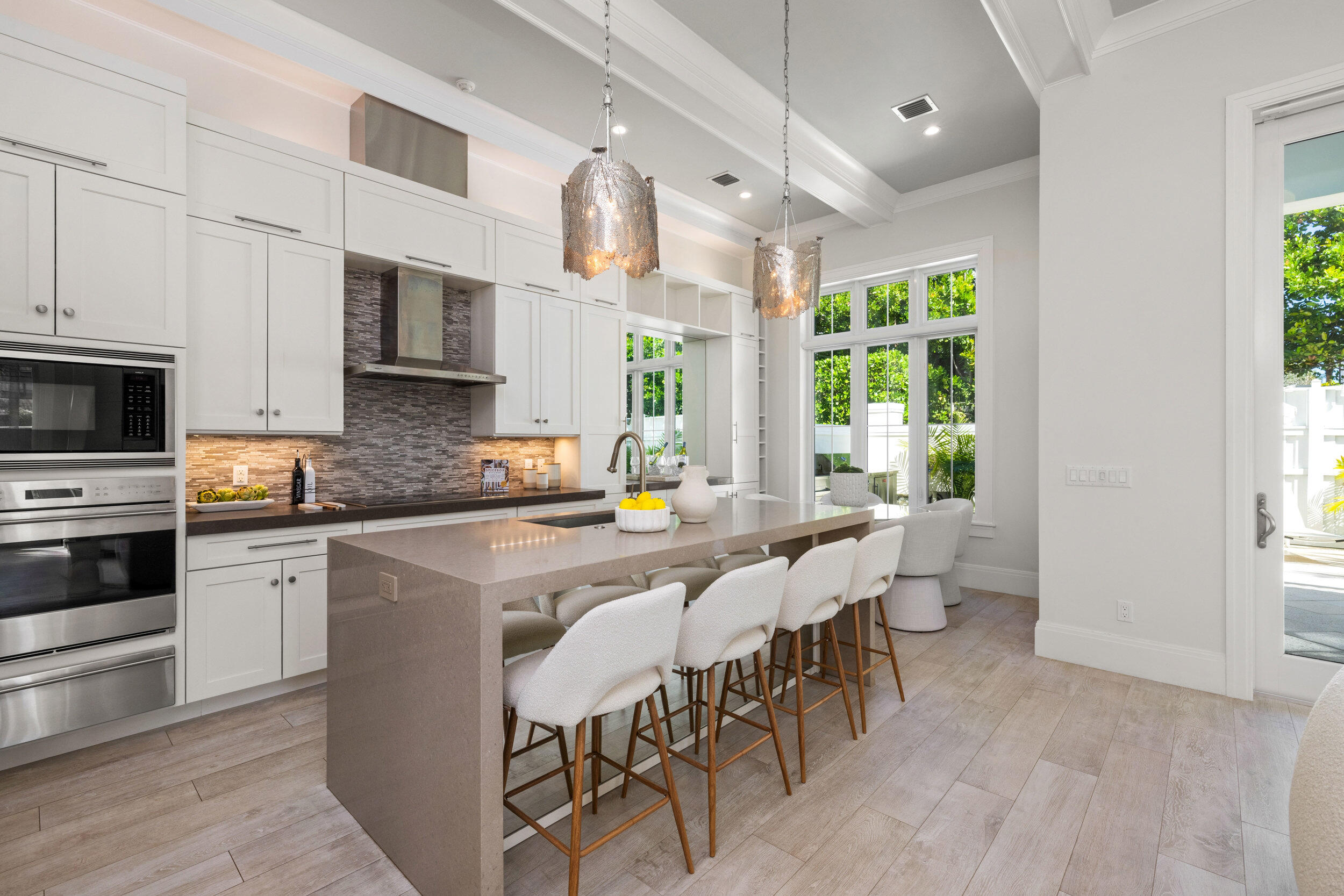 17 Adams Road Ocean Ridge, FL 33435 - Photo 7 of 41 a large white kitchen with stainless steel appliances a stove a table and chairs