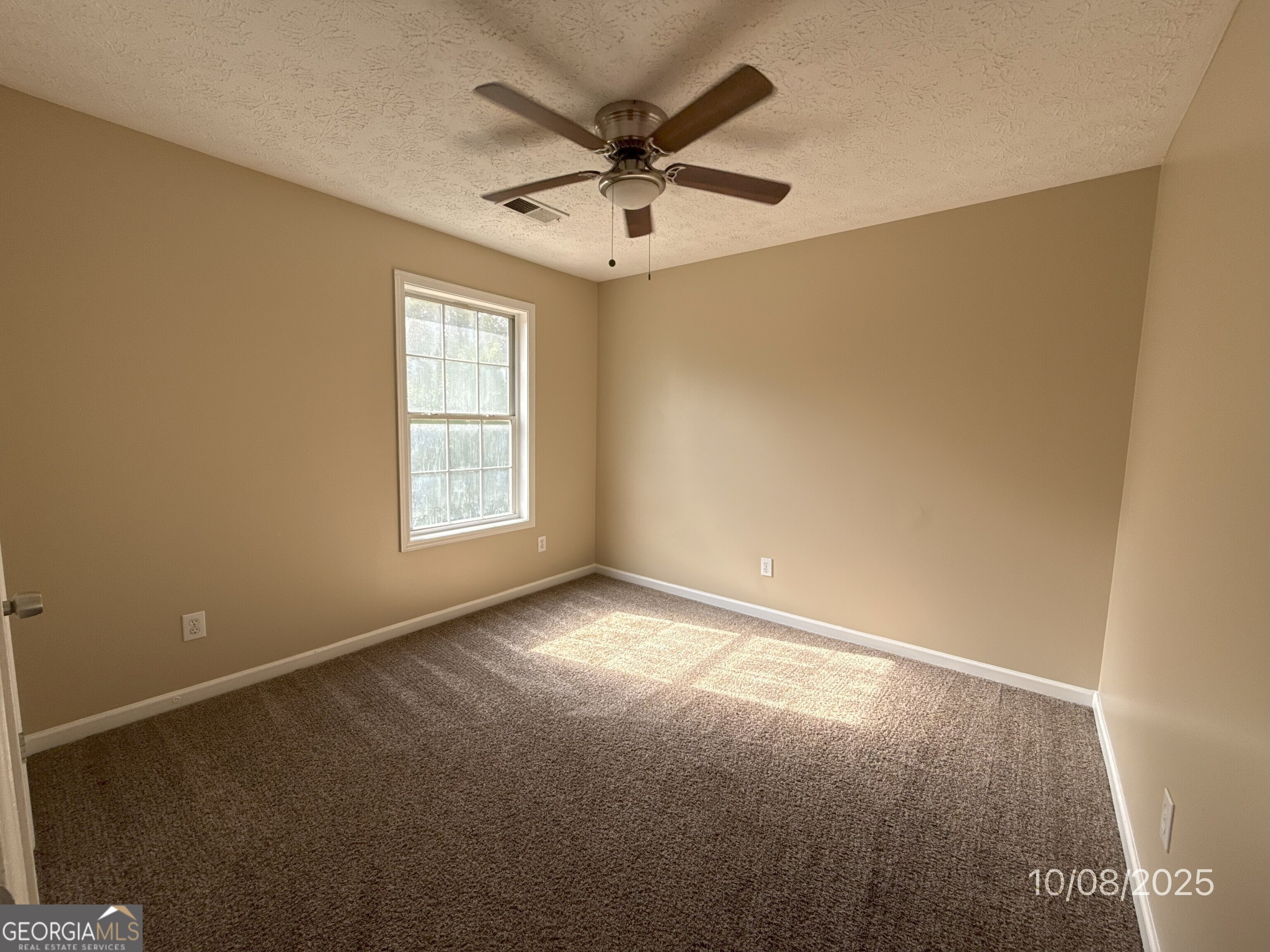 124 Waters Edge Drive Locust Grove, GA 30248 - Photo 13 of 13 an empty room with windows and ceiling fan