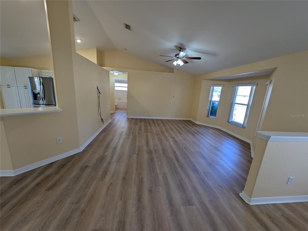9573 Southwest 53rd Circle Ocala, FL 34476 - Photo 18 of 85 a view of an empty room with a window and wooden floor