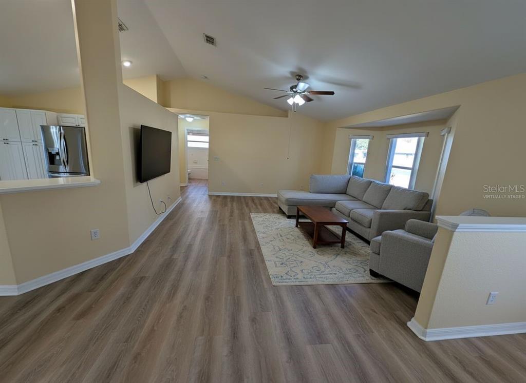 9573 Southwest 53rd Circle Ocala, FL 34476 - Photo 19 of 85 a living room with furniture and a flat screen tv