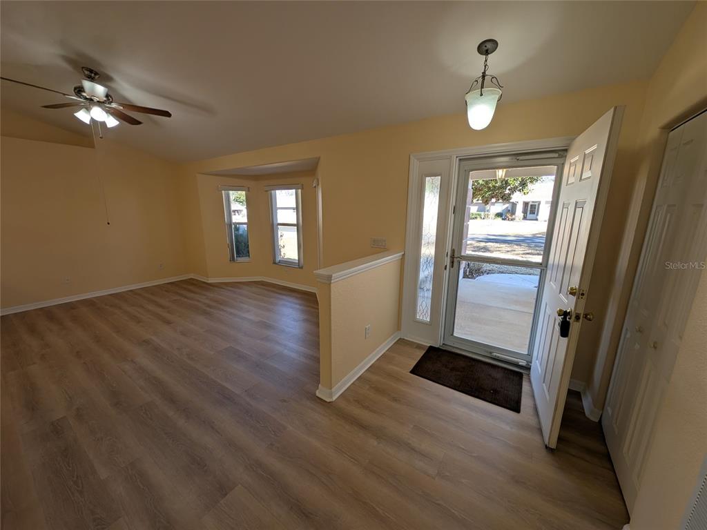9573 Southwest 53rd Circle Ocala, FL 34476 - Photo 20 of 85 a view of an empty room with wooden floor and a window