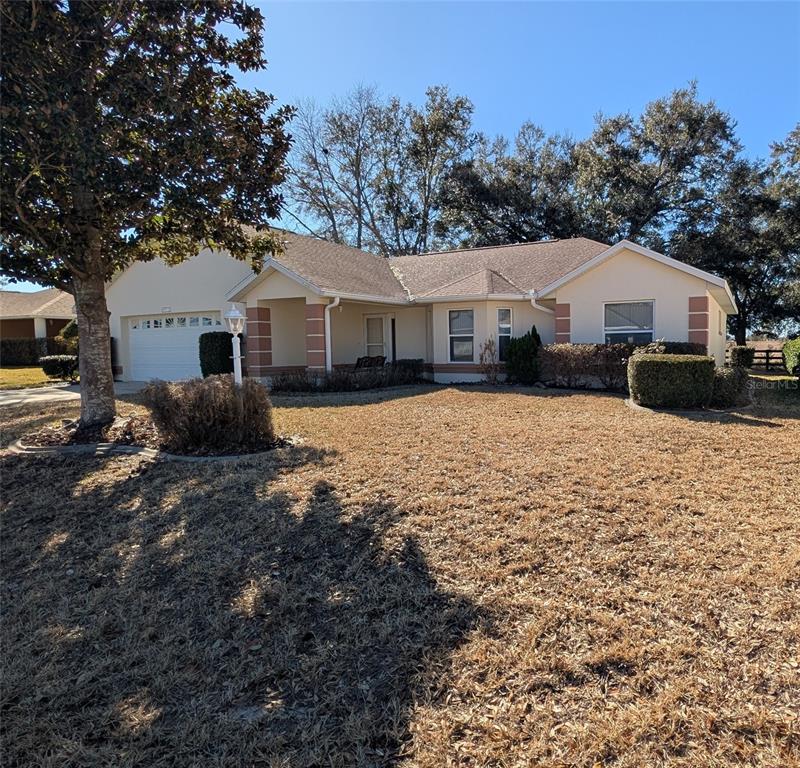 9573 Southwest 53rd Circle Ocala, FL 34476 - Photo 2 of 85 a front view of a house with a yard covered in snow