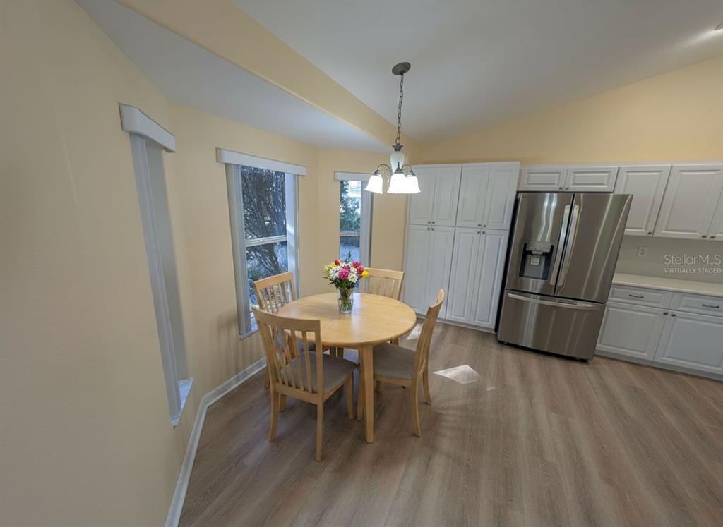 9573 Southwest 53rd Circle Ocala, FL 34476 - Photo 30 of 85 a kitchen with stainless steel appliances a dining table chairs and granite counter tops