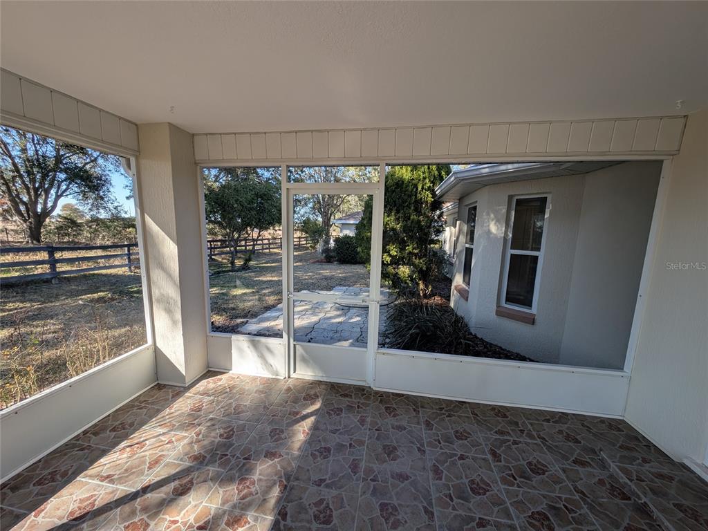 9573 Southwest 53rd Circle Ocala, FL 34476 - Photo 50 of 85 a view of a living room and a floor to ceiling window