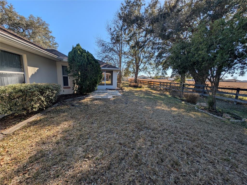 9573 Southwest 53rd Circle Ocala, FL 34476 - Photo 5 of 85 a view of a backyard with plants and large trees
