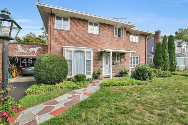 a front view of a house with garden
