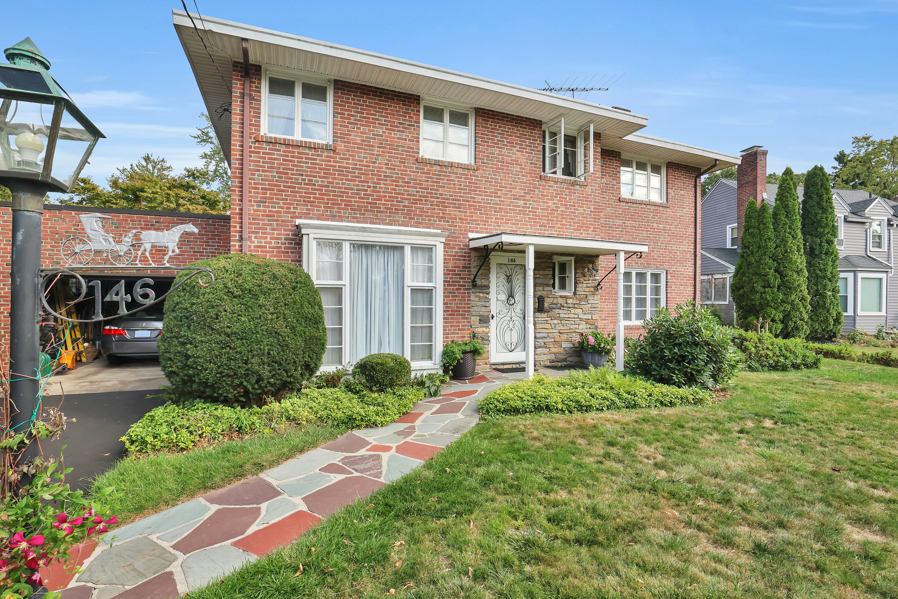 a front view of a house with garden