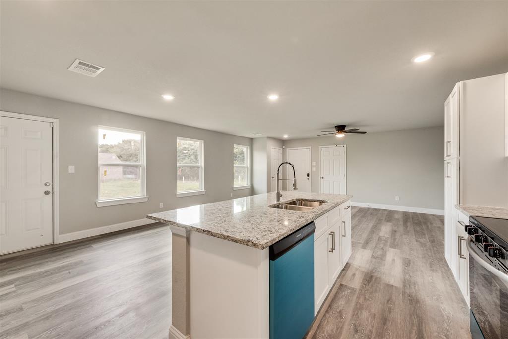 3153 Stag Road Dallas, TX 75241 - Photo 5 of 15 a kitchen with a sink stove and cabinets