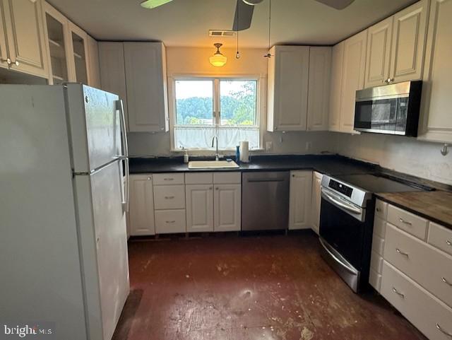 13342 Marsh Road Bealeton, VA 22712 - Photo 11 of 25 a kitchen with stainless steel appliances a sink a stove a microwave a refrigerator a window