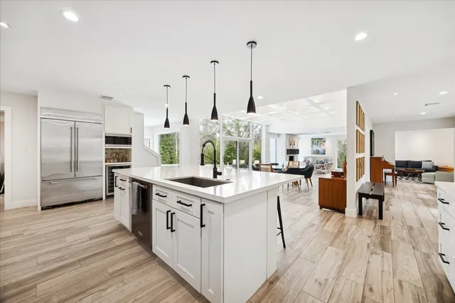 a large kitchen with stainless steel appliances lots of counter space sink and cabinets