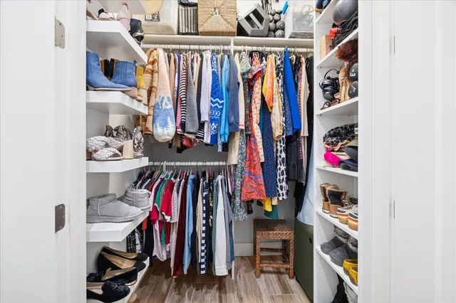 a large white bathroom with a double vanity sink a mirror and a shower