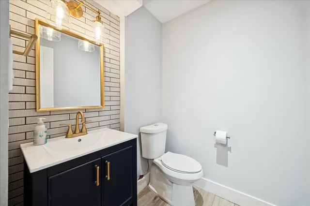 a room with white cabinets and wooden floor