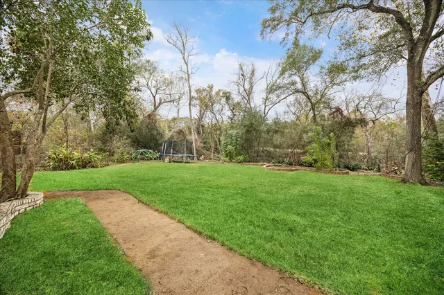 a front view of a house with a yard and sitting area
