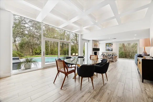 a living room with furniture fireplace and a large window