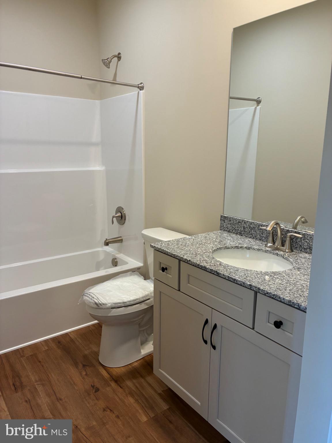 602 Greenbriar Path Cochranville, PA 19330 - Photo 15 of 20 a bathroom with a granite countertop toilet a sink and bathtub