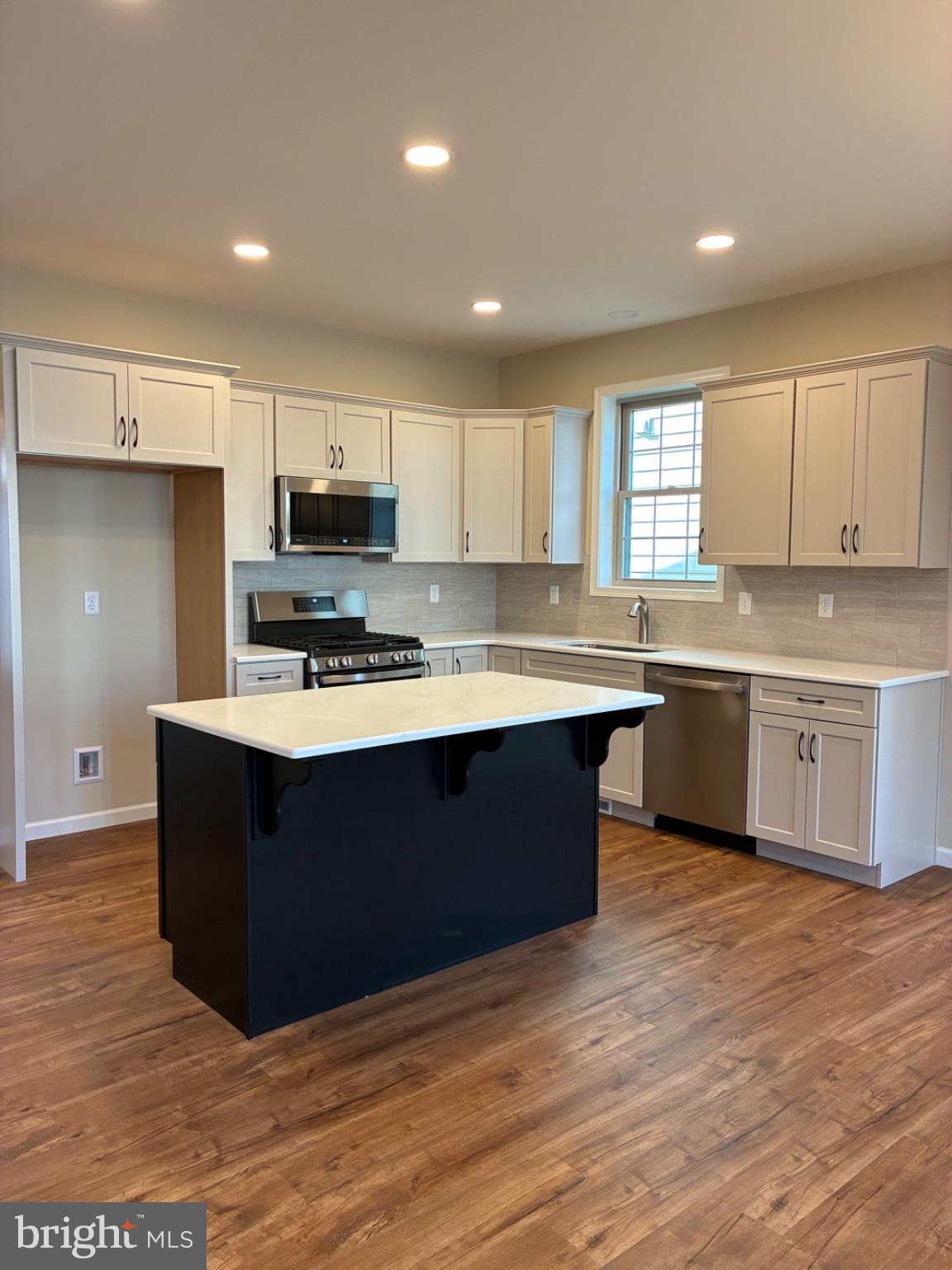 602 Greenbriar Path Cochranville, PA 19330 - Photo 3 of 20 a kitchen with stainless steel appliances granite countertop a stove a sink and a microwave