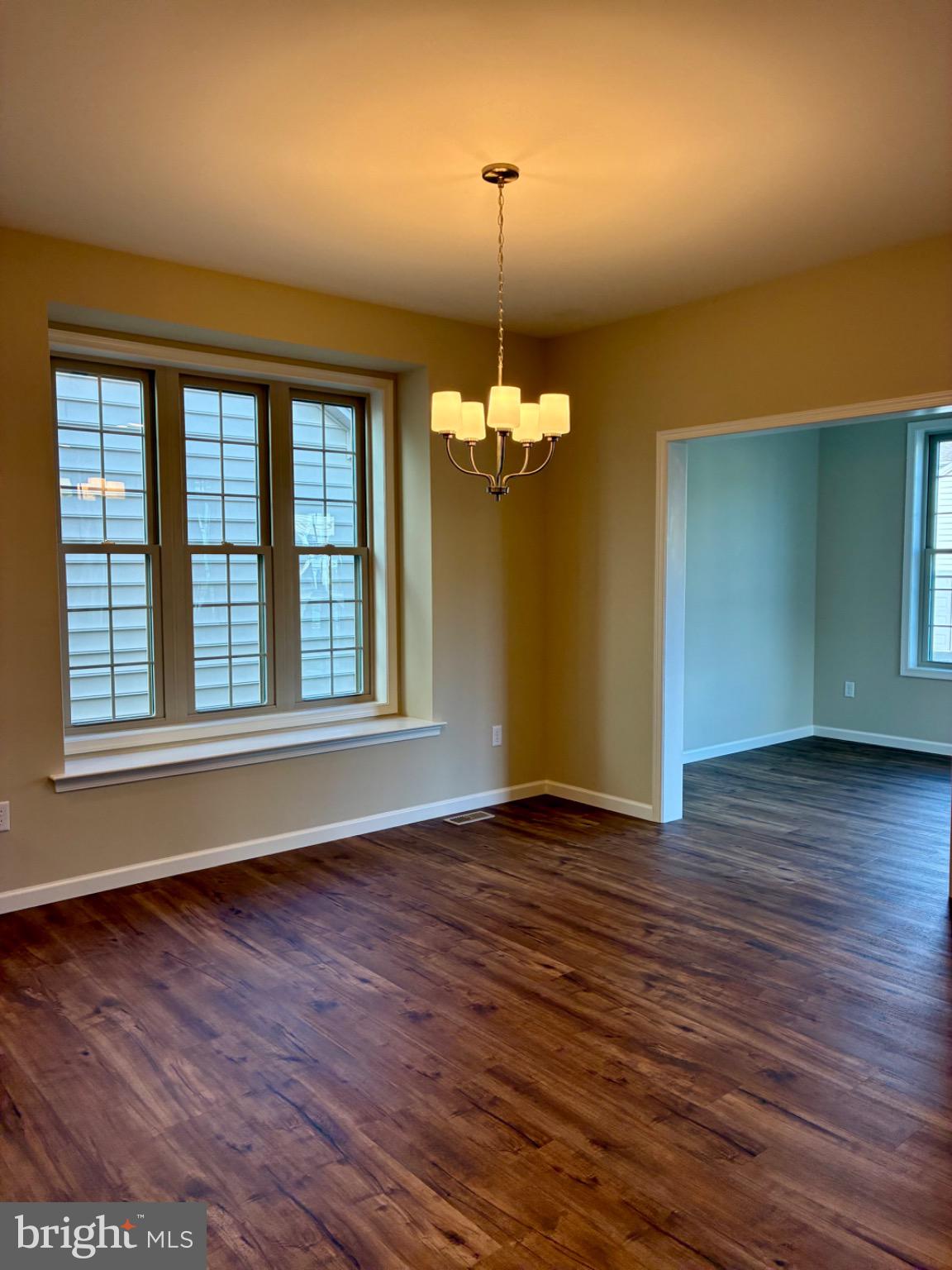 602 Greenbriar Path Cochranville, PA 19330 - Photo 5 of 20 a view of an empty room with wooden floor and a window