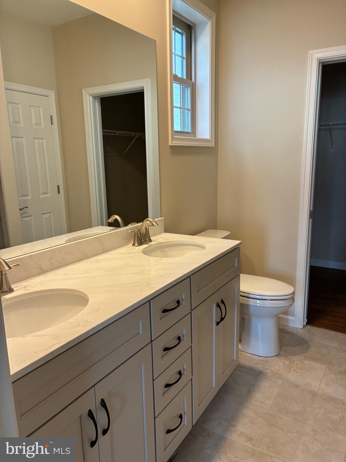 602 Greenbriar Path Cochranville, PA 19330 - Photo 10 of 20 a bathroom with a granite countertop sink a toilet and a mirror