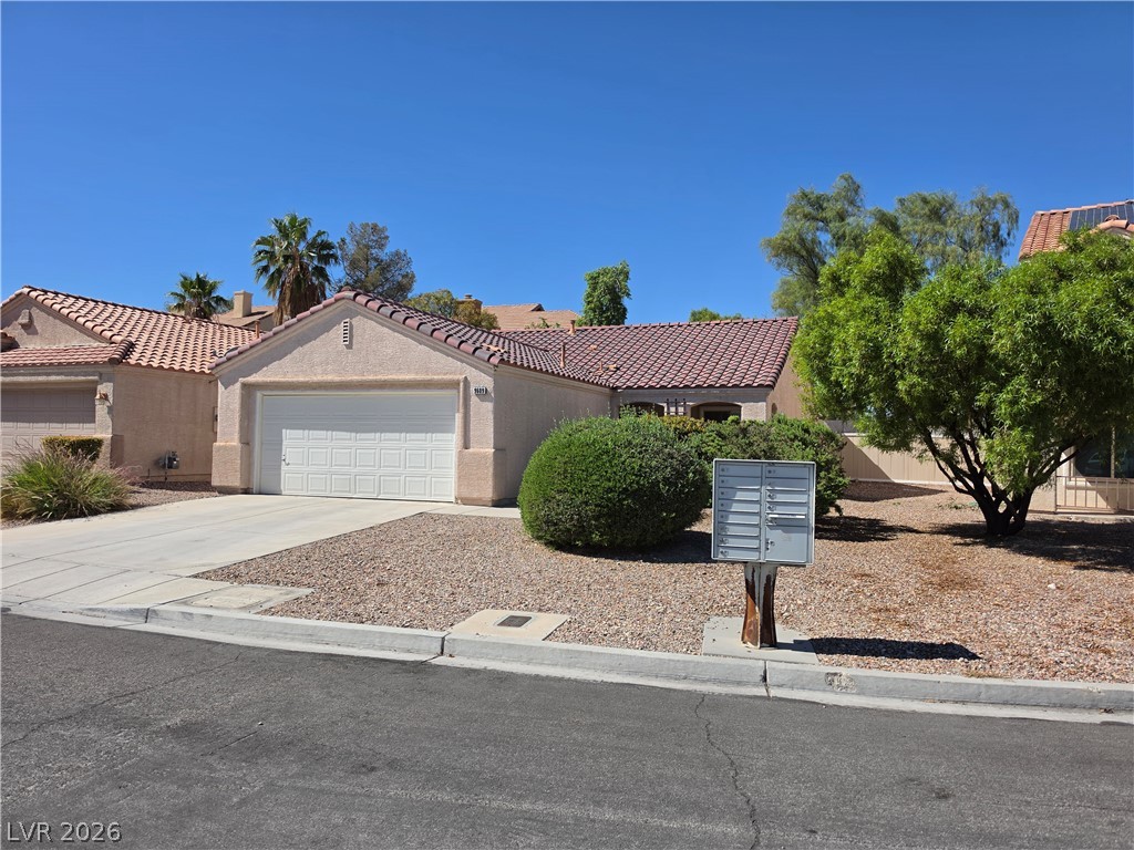 9609 Crystal Ridge Road Las Vegas, NV 89123 - Photo 21 of 21 Clay tile roofs and desert landscaping create classic southwestern appeal under a clear blue sky.