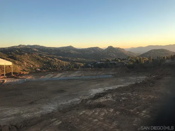 a view of a town with mountains in the background