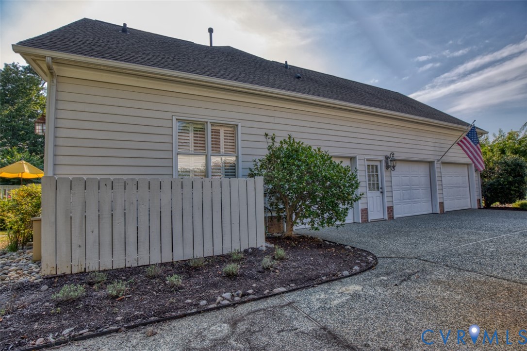 9960 Mill Pond Road Toano, VA 23168 - Photo 39 of 42 Two-car garage with overhead doors, an exterior si